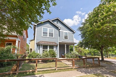 Traditional-style house with a fenced front yard,