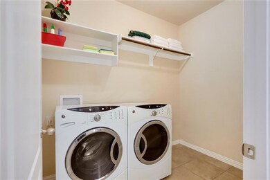 Washroom with washer and clothes dryer and light 