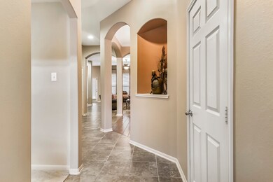 Door to the right leads to the garage and hallway to the left leads to the secondary bedrooms.