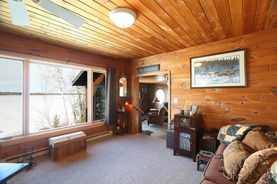 Interior space with wood walls, a baseboard heatin