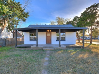 View of front of house with covered porch and brick siding