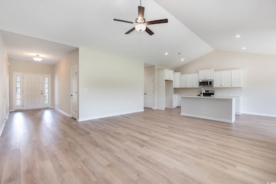 Unfurnished living room with ceiling fan, light wood finished floors, baseboards, high vaulted ceiling, and recessed lighting