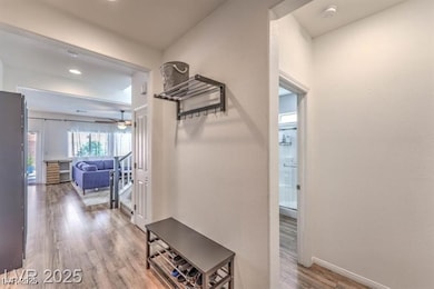 Corridor featuring light wood finished floors and recessed lighting