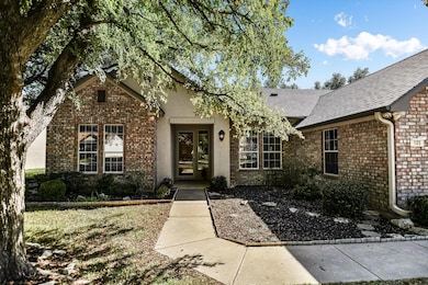 Doorway to property featuring brick siding and ro