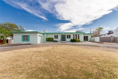 Ranch-style home with a front lawn, fence, and an