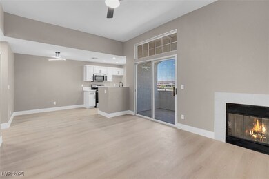 Unfurnished living room featuring a ceiling fan, l