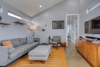 Living room with finished concrete flooring, high