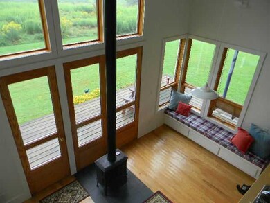 Living Room. View from loft.  Built in storage ben