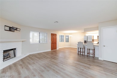 Living room with visible vents, a brick fireplace,