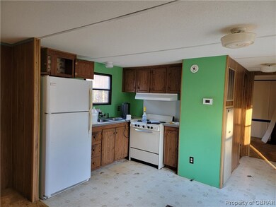 Kitchen featuring sink, a textured ceiling, white