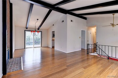 The living room and dining room feature a beamed c