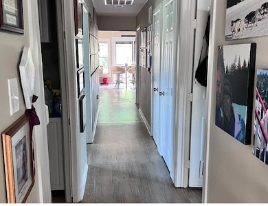 Corridor featuring dark wood-style flooring