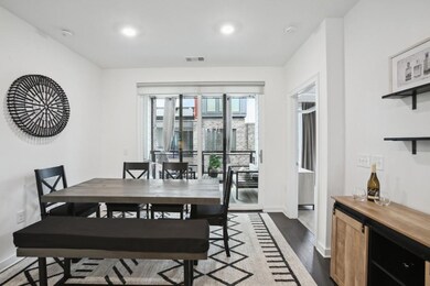 Dining room with baseboards, dark wood-type flooring, recessed lighting, and a bar