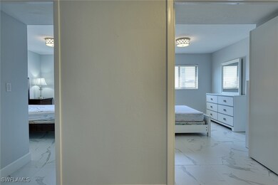 Bedroom with light marble finish flooring and base