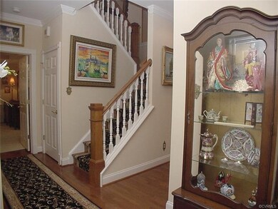 Foyer with crown molding & large coat closet