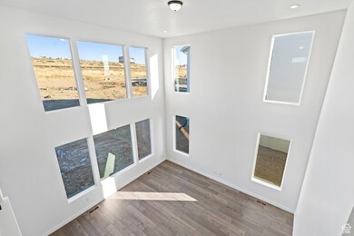Empty room with wood finished floors and a high ceiling