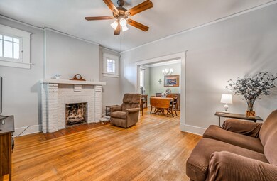 Living room with ceiling fan with notable chandeli