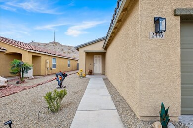 Doorway to property featuring stucco siding and a