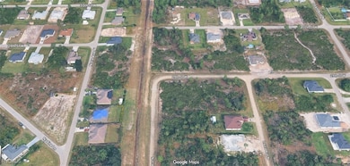 Aerial view of property and surrounding area with nearby suburban area