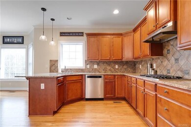 Another view of the kitchen with recessed and pend