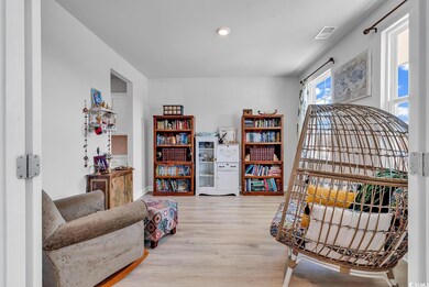 Living area with wood finished floors and visible vents