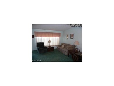 Cozy living room with large picture window and din