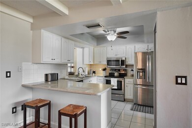 Kitchen featuring backsplash, appliances with stai