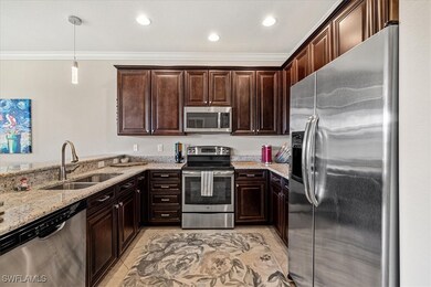 Kitchen featuring light stone counters, dark brown