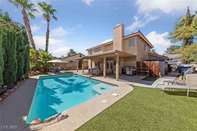 View of pool featuring a patio area, a fenced backyard, and grilling area