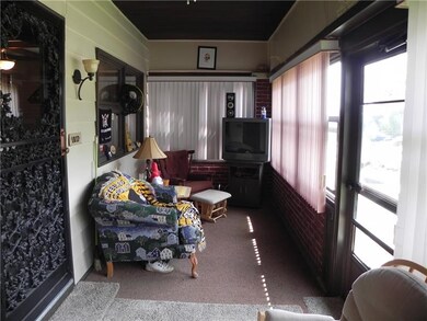 SUN PORCH  WITH SCREENED WINDOWS AND SWING ON THE 