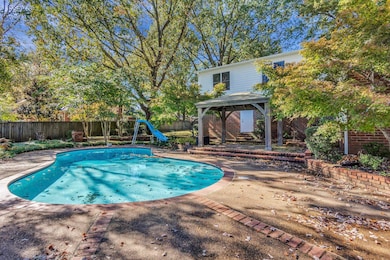 View of pool featuring a gazebo, a patio, a water slide, and a fenced backyard