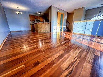 Living Room with kitchen, dining, half bath, and stairs