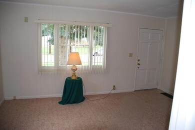 Living Room: new neutral carpet, storm door w/ screen & lots of natural light. Access to the kitchen, full bathroom and bedrooms.