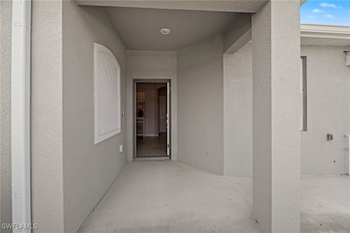 Doorway to property with stucco siding