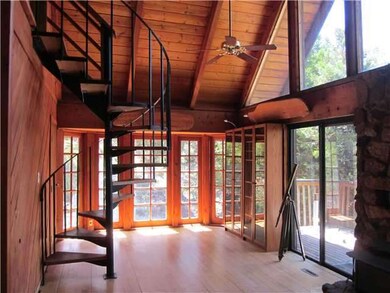 Large windows all around. Two sliding glass doors 