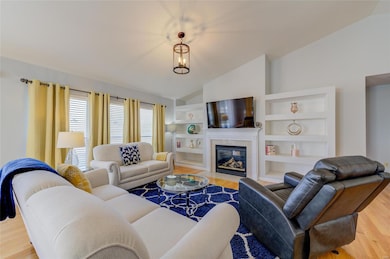 The great room has lots of light, vaulted ceilings