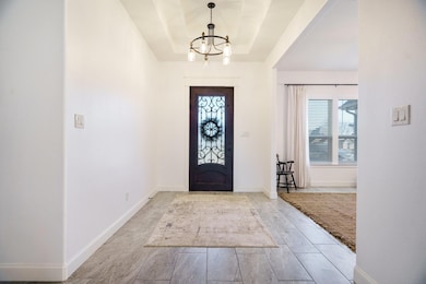 Entrance foyer featuring a notable chandelier and 