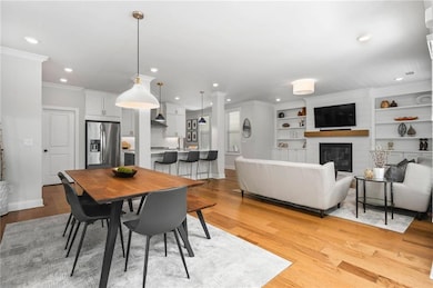 Dining room featuring a large fireplace, baseboard