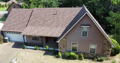 View of front facade with a garage and covered por