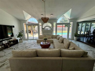 Living room featuring a chandelier, a textured cei