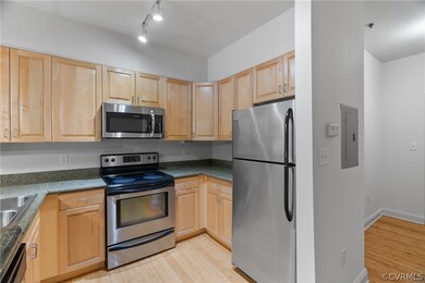 Kitchen featuring rail lighting, light brown cabin