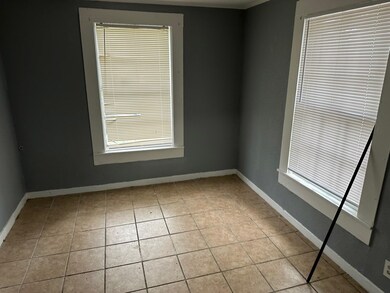 Unfurnished room featuring light tile patterned fl