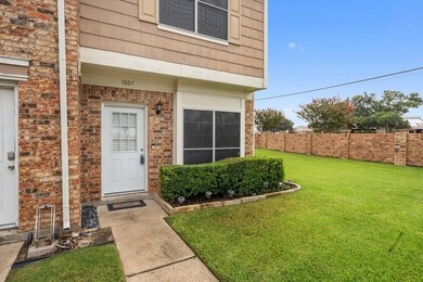 Entrance to property with a lawn