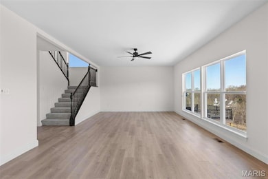 Unfurnished living room featuring ceiling fan, a healthy amount of sunlight, and light wood-type flooring