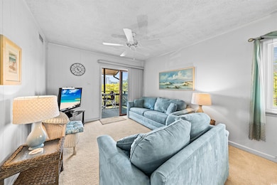 Carpeted living room with crown molding, baseboard