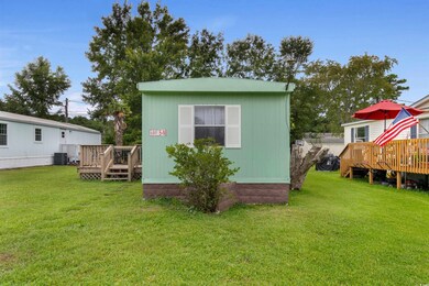 Rear view of property featuring central AC unit, a