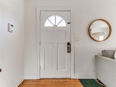 Entrance foyer with wood-type flooring