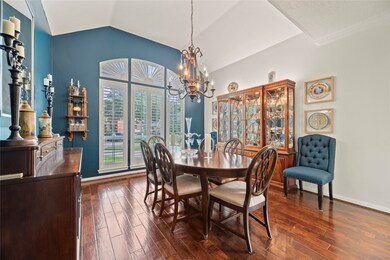 Formal dining room boasts wood flooring, window sh