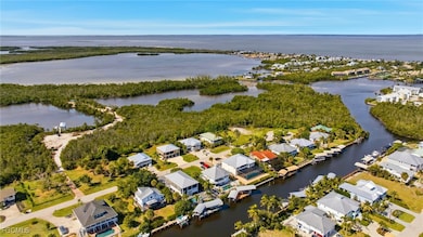 Aerial view of property's location with a large body of water and nearby suburban area