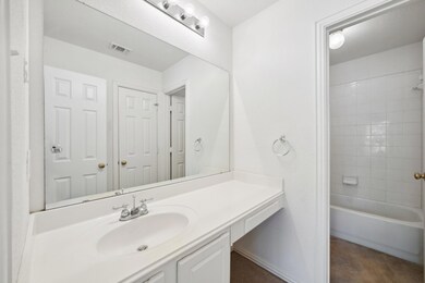 Bathroom featuring tiled shower / bath and vanity